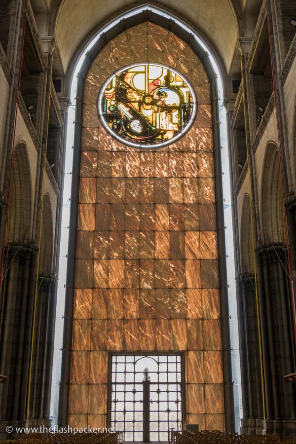 modern circular stained glass window in lille cathedral filled with abstract symbols