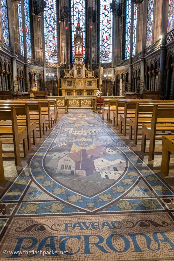 chapel with a mosaic floor and gilded altar and stained glass windows