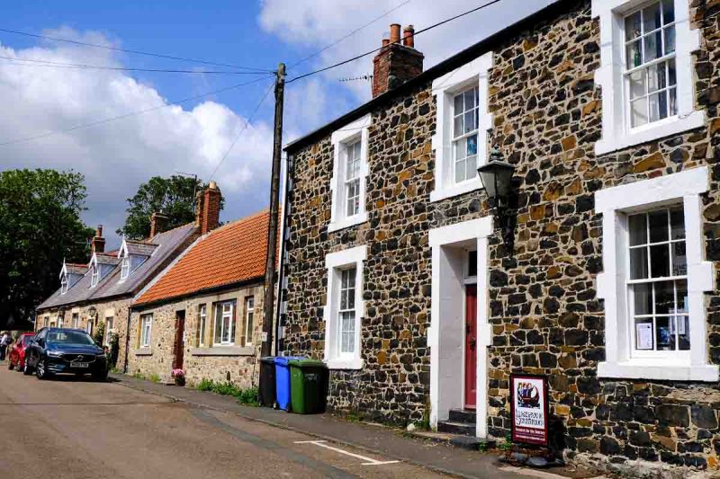 stone cottages on a street in lindisfarne england