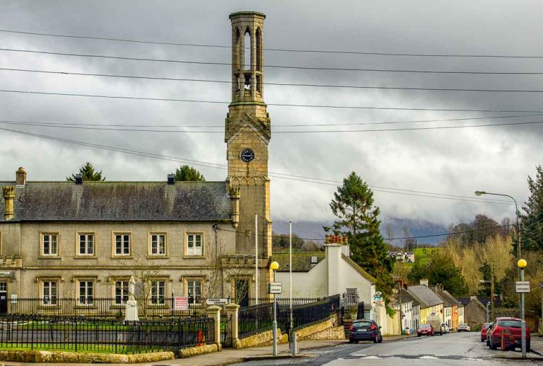 main street in borris carlow with church with tall bell tower and clock