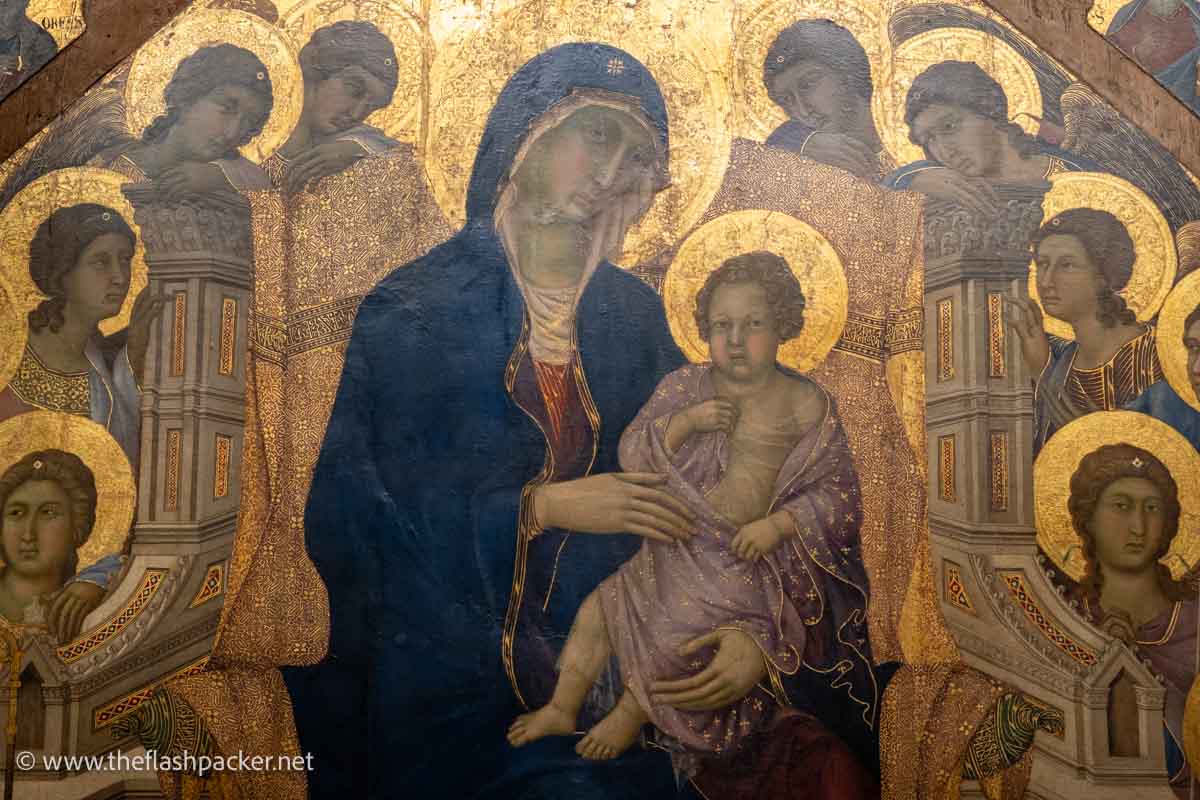 gilded medieval painting of madonna and child with angels