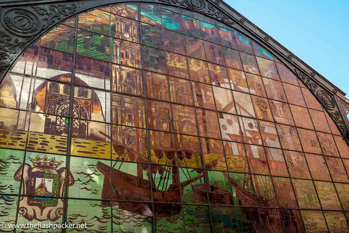 brightly coloured stained glass window depicting scenes of malaga