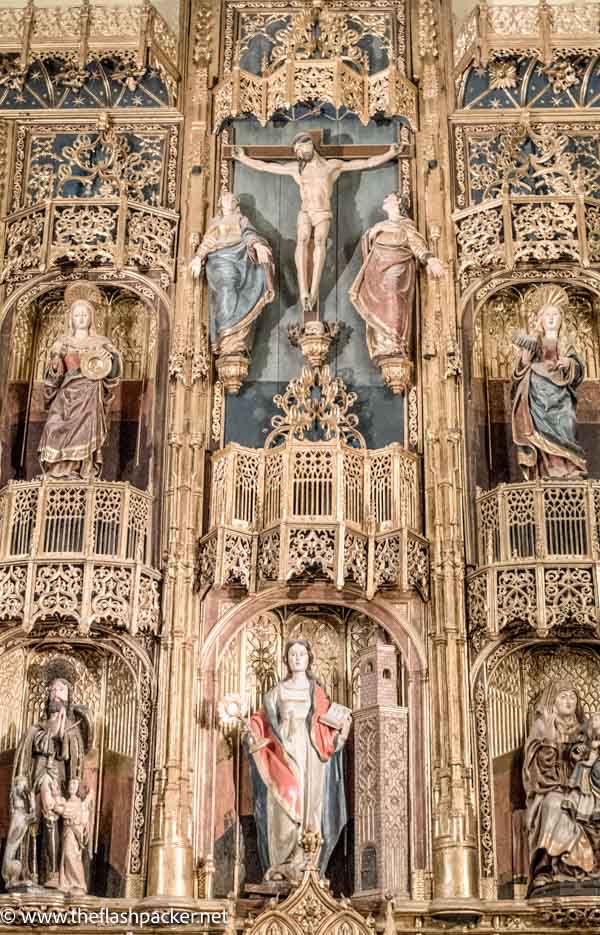 An ornate gilded altarpiece with statues of religious figures is one of the things that malaga cathedral is known for