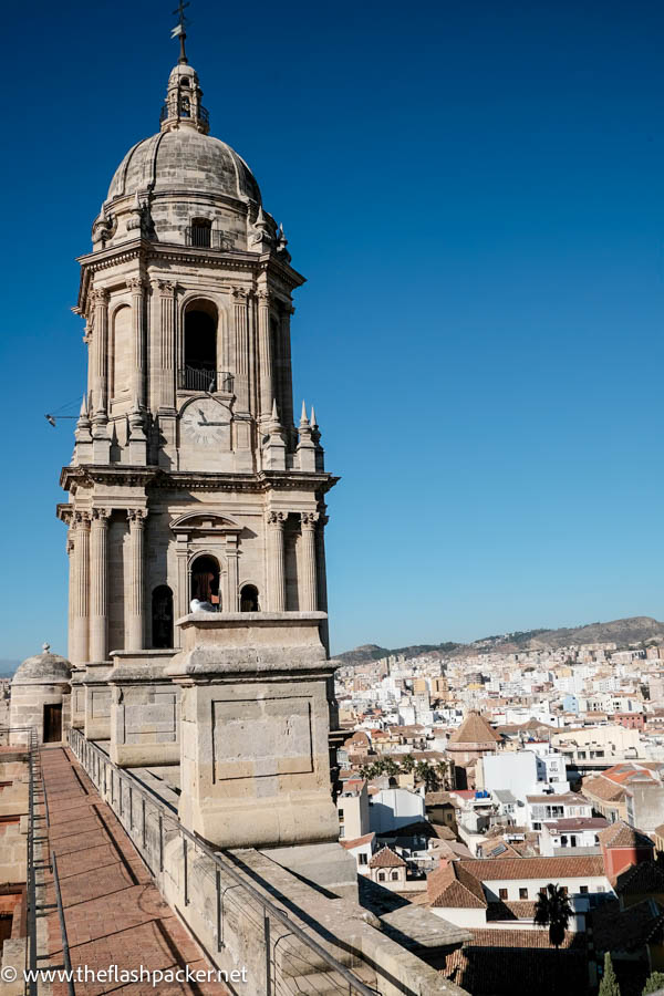 bell tower of malaga cathedral and rooftops of city below