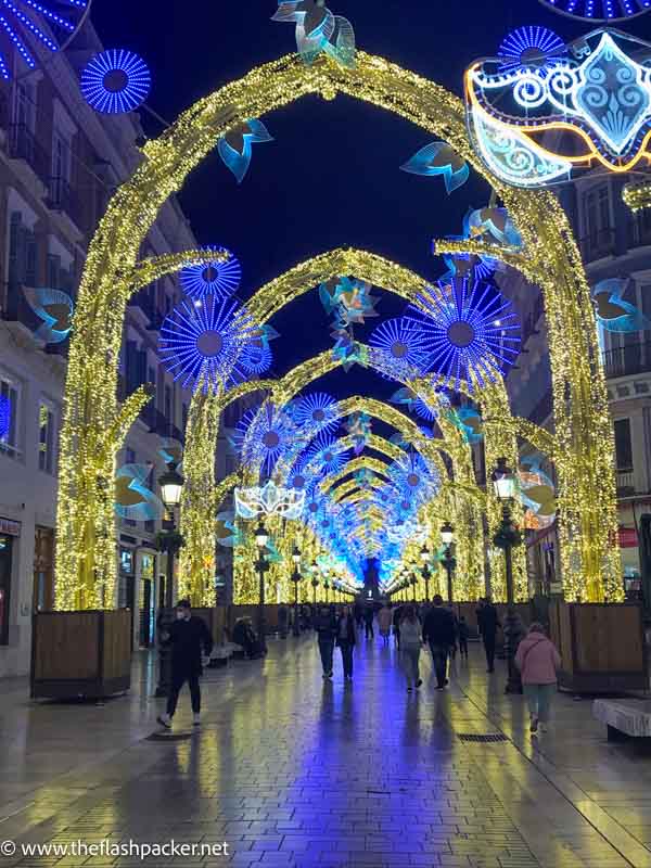 arches in street at night lit with festive lights