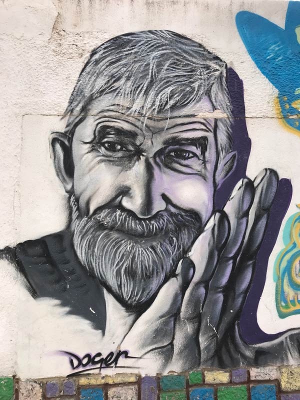 urban art on a wall of an old man with a beard