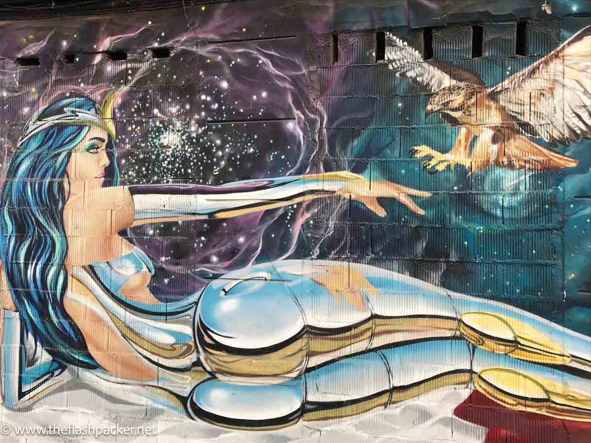 street art of reclining female figure with an eagle