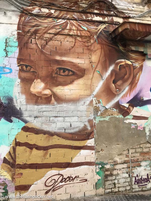 realistic image of a young boy on a wall in malaga spain