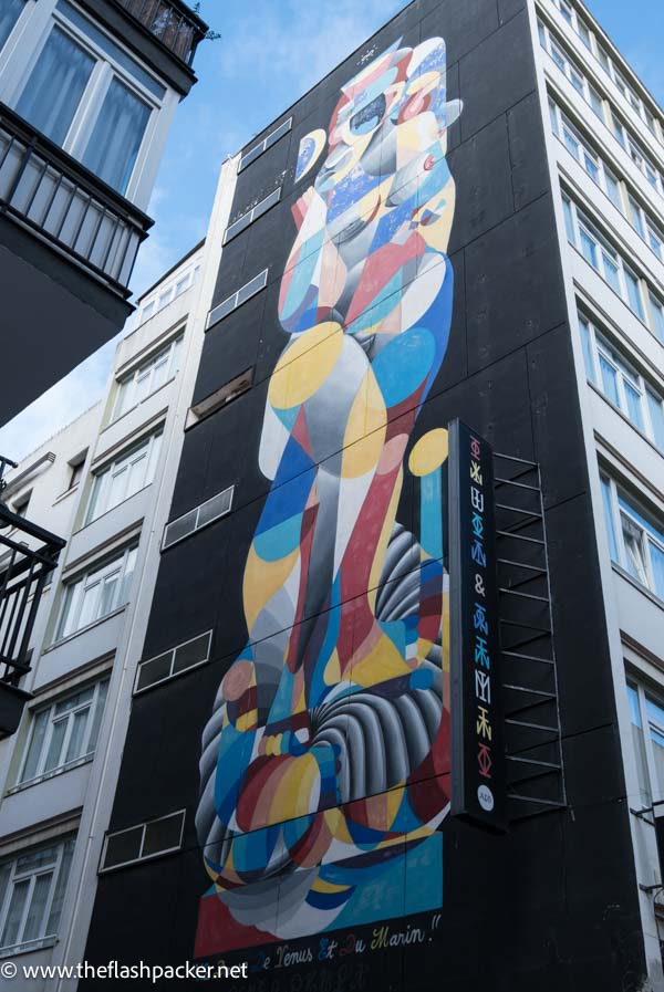 brightly coloured abstract mural on the side of a building