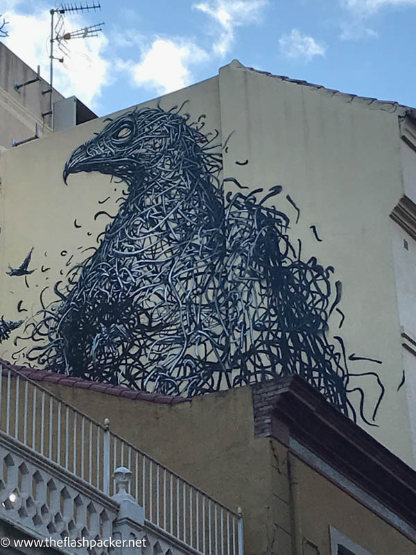 large mural of a bird on the side of a building