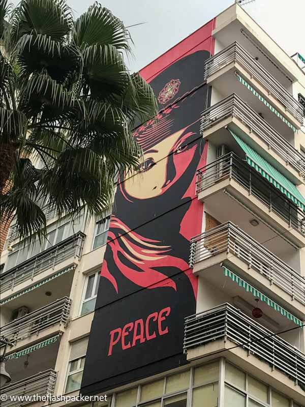 street art of a woman in veil with the word peace