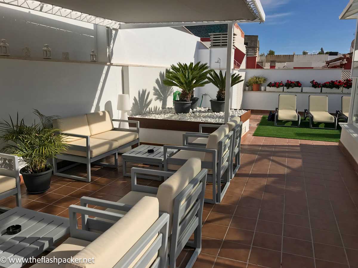 terrace of apartment with sun loungers and sofas