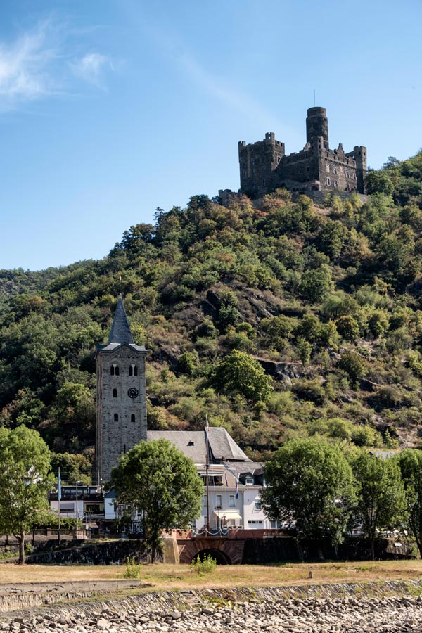 old rhine castle on top of a hall with a church below it