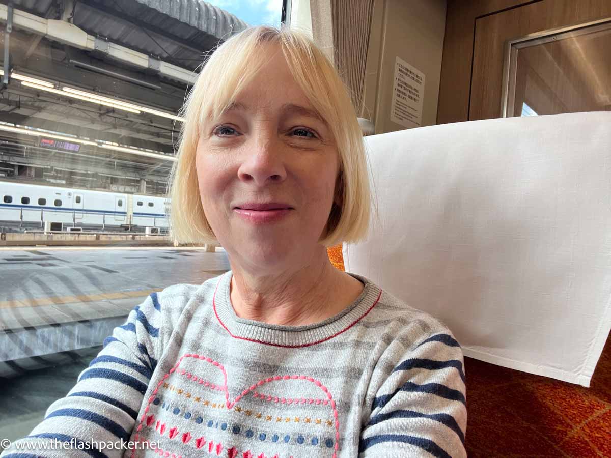 a blond haired middle-aged sitting in a train