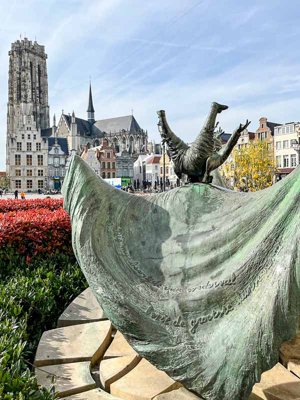 bronze sculpture of a drunken man falling backwards