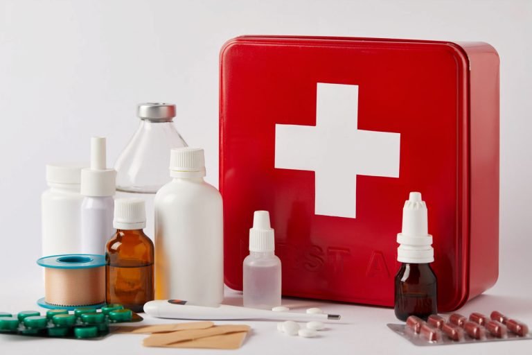 first aid kit with a variety of medicine bottles that could be in a travel medicine kit