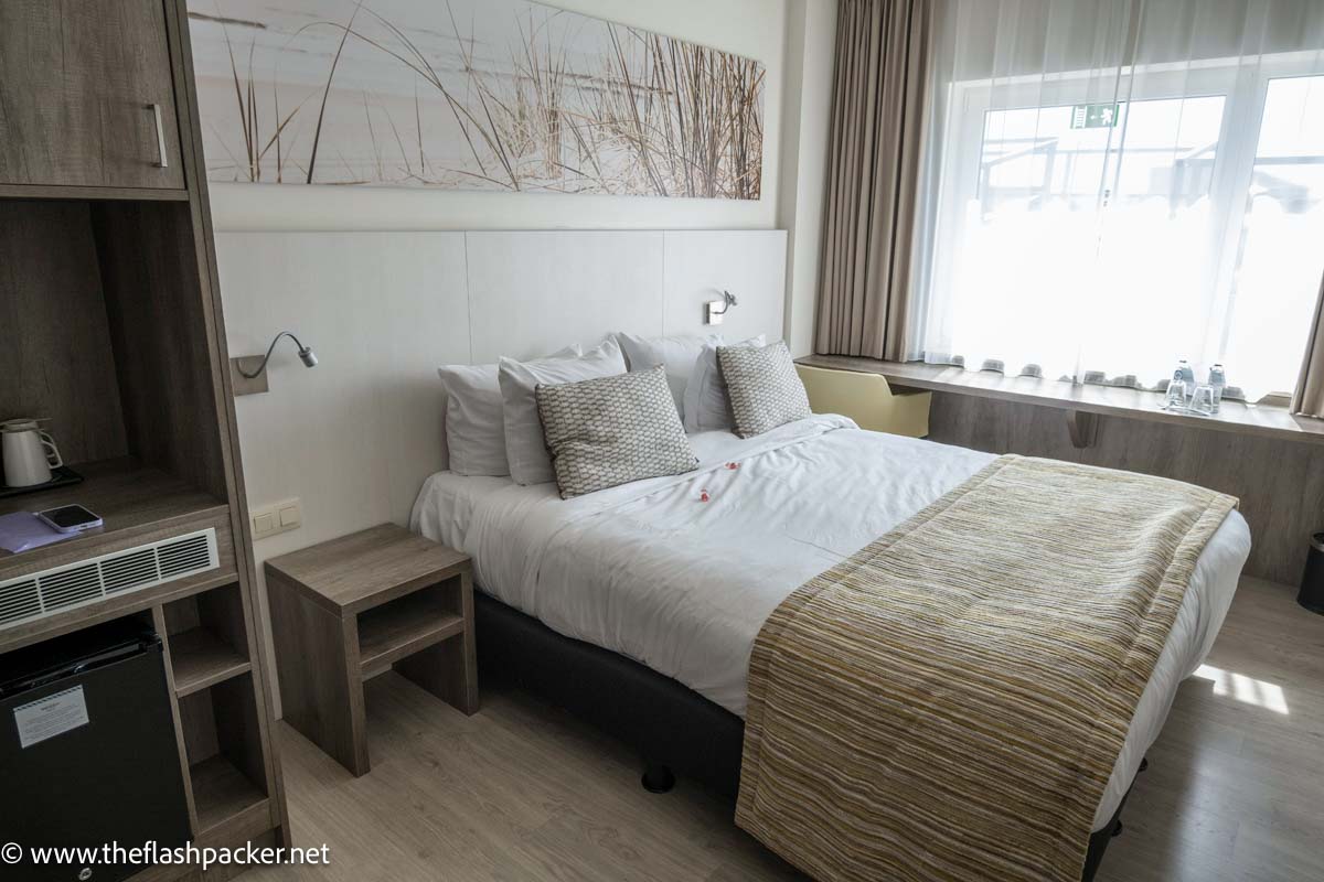 room at oostend mercure hotel with double bed and wooden furniture