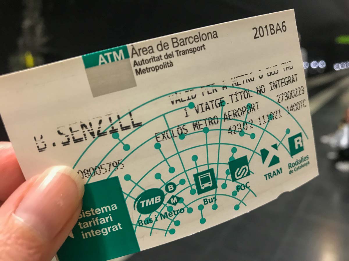 person holding a barcelona metro ticket