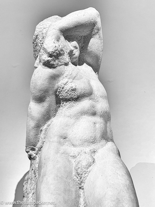 rough statue of a young man