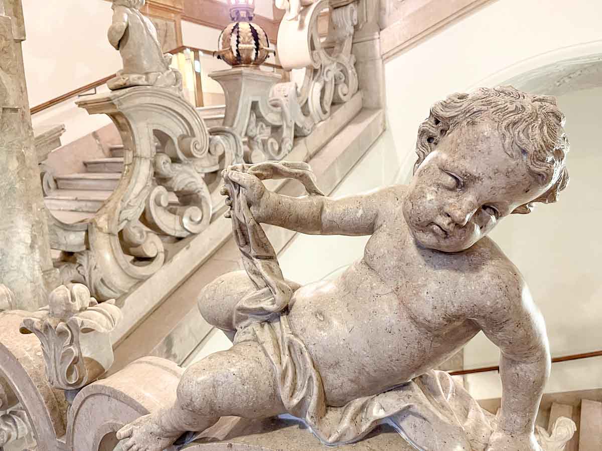 marble sculpture of cherub on staircase at mirabell palace