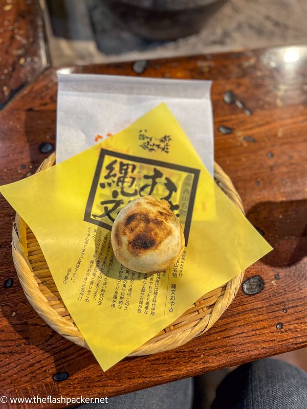 large grilled dumpling on a yellow napkin