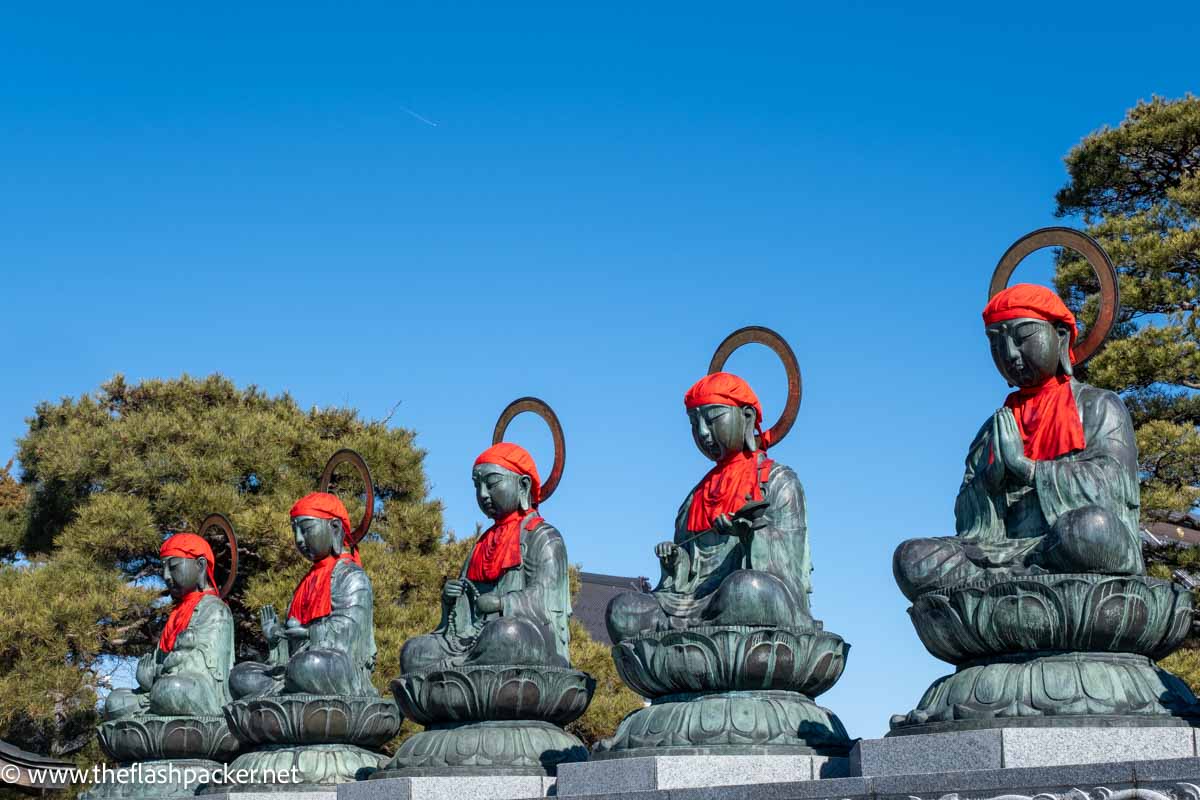 a series of small seated stone buddha statues