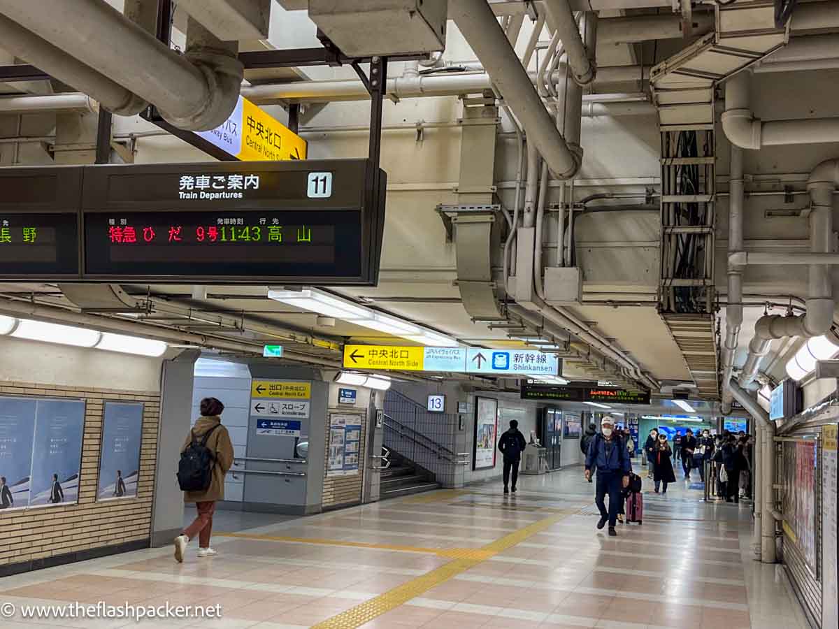 people walking along concourse of nagoya station japan