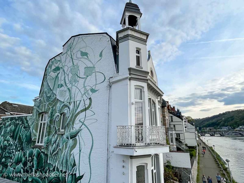 exterior of white art nouveau building next to a river