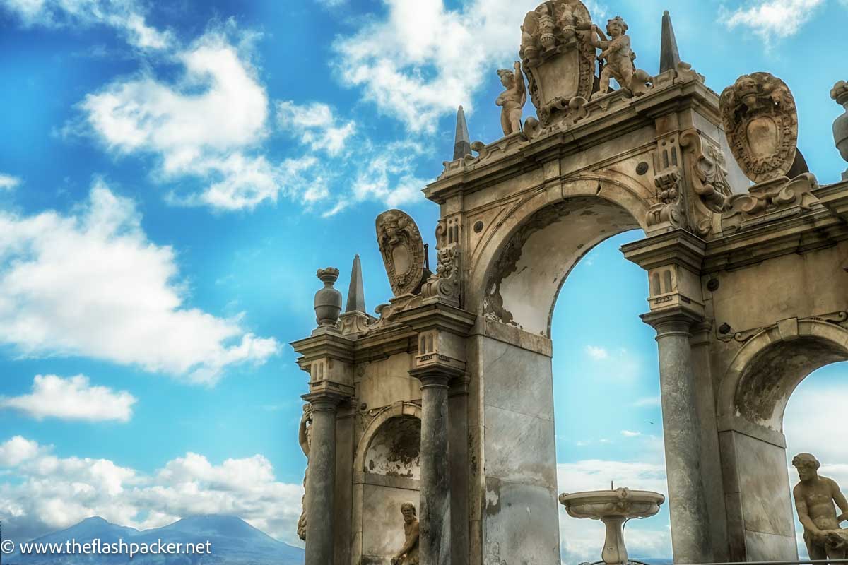 triumphal arch with peak of vesuvius in background