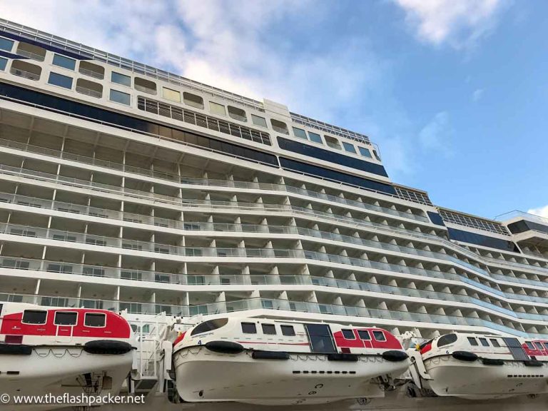 exterior of cruise ship cabins with balconies and lifeboats