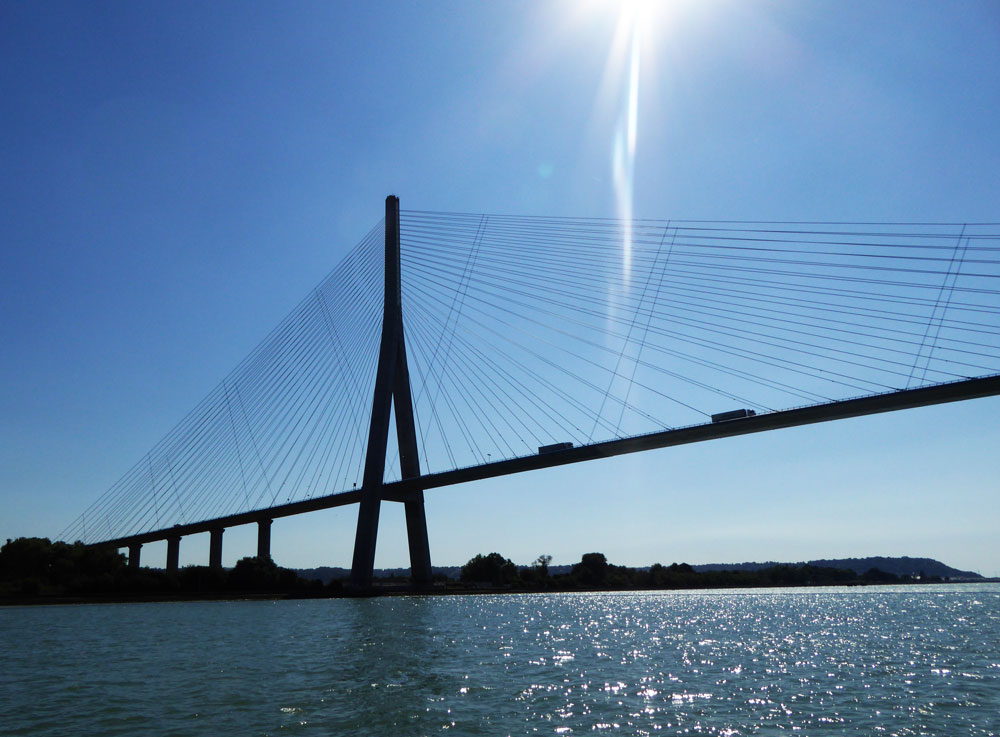 massive suspension bridge against blue sky in normandy france