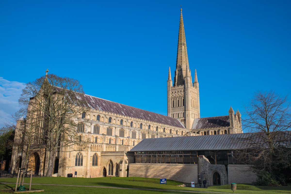 exterior of norwich cathedral under clear blue sky