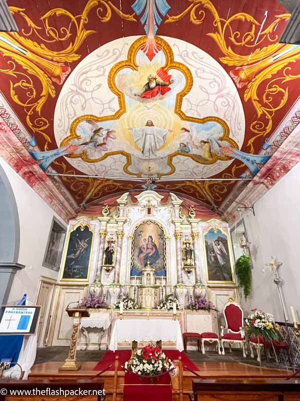 altar and brightly painted ceiling of church