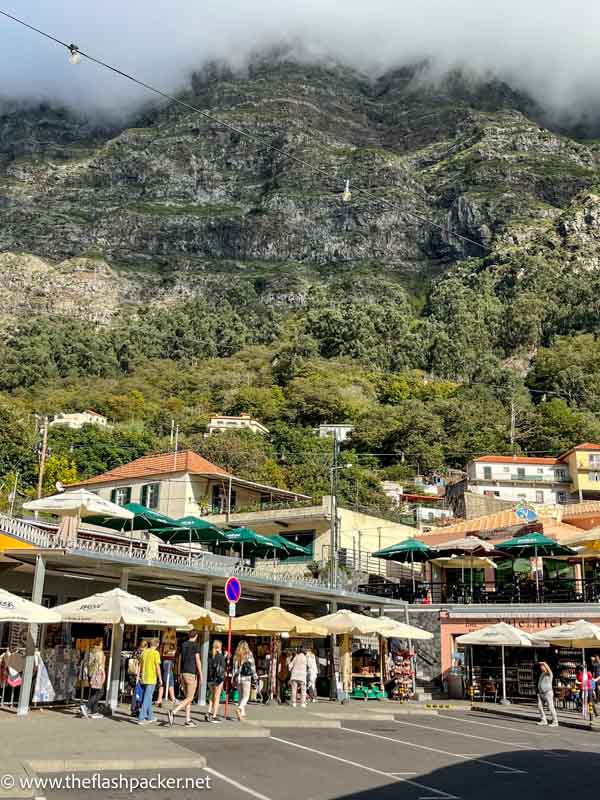 people walking in small town square of curral das freiras madeira