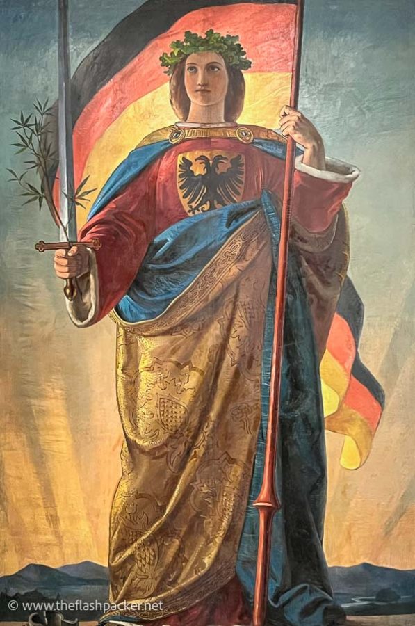 painting of a woman wearing a laurel wreath carrying a sword and flag of germany