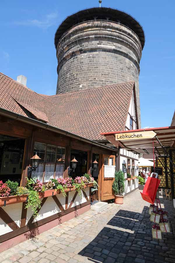 narrow lane of medieval buildings and large round tower