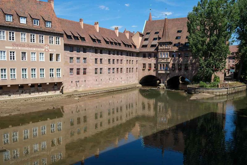 medieval building with reflection in river