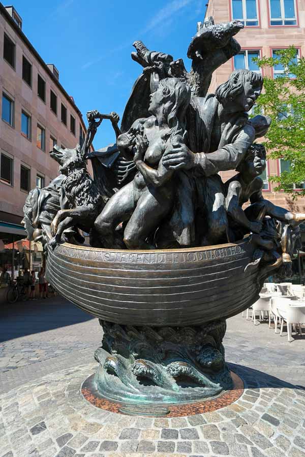 bronze sculpture of group of figures in a boat