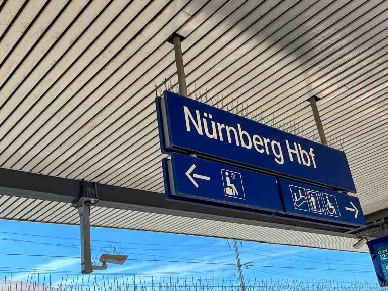 station sign for nürnberg on platform of train station