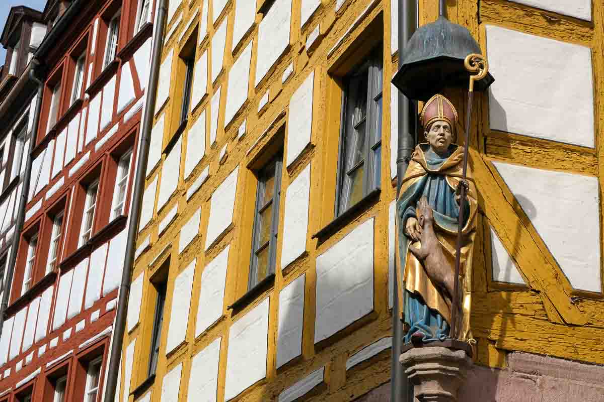 statue at gable of half timbered house