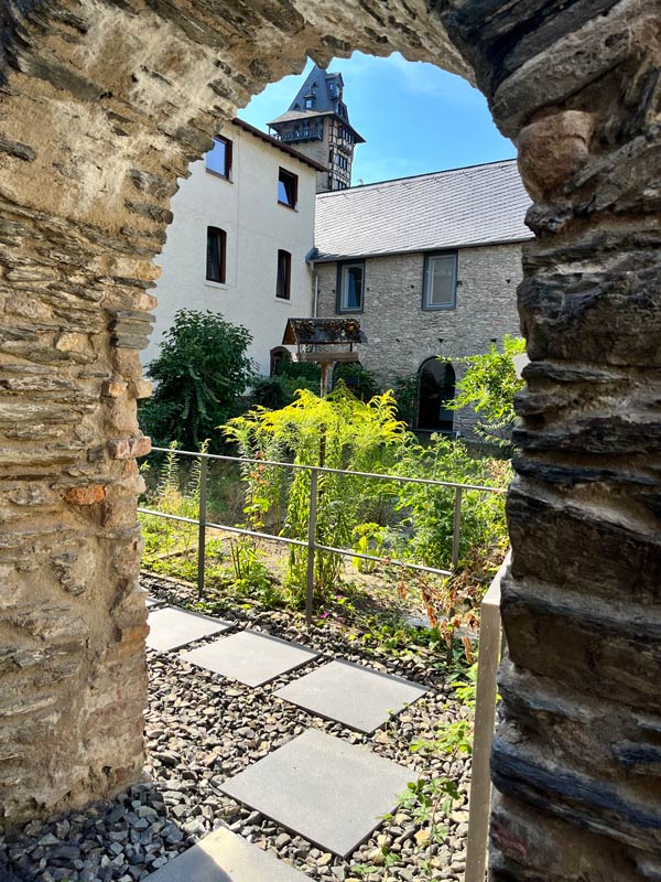 small garden seen through a stone arch