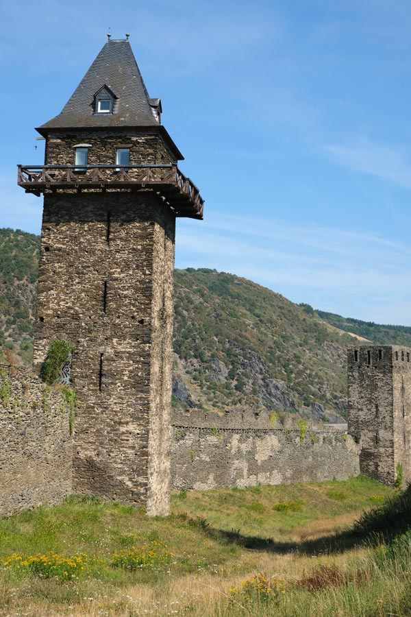 a tall tower and a smaller one which are part of a town wall