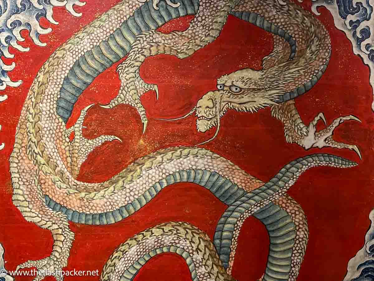 vibrant painting of a dragon on a red background