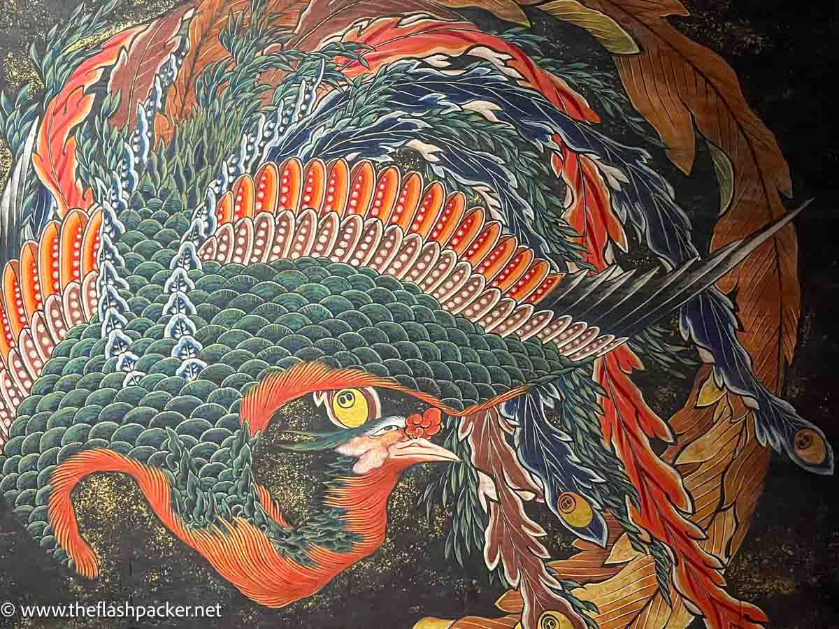 vibrant painting of a phoenix on a green background