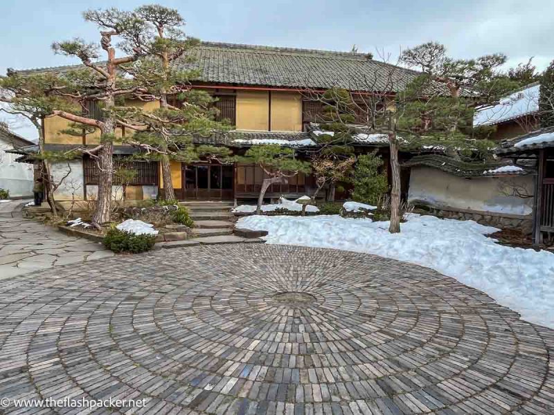 courtyard in winter in front of traditional japanese building