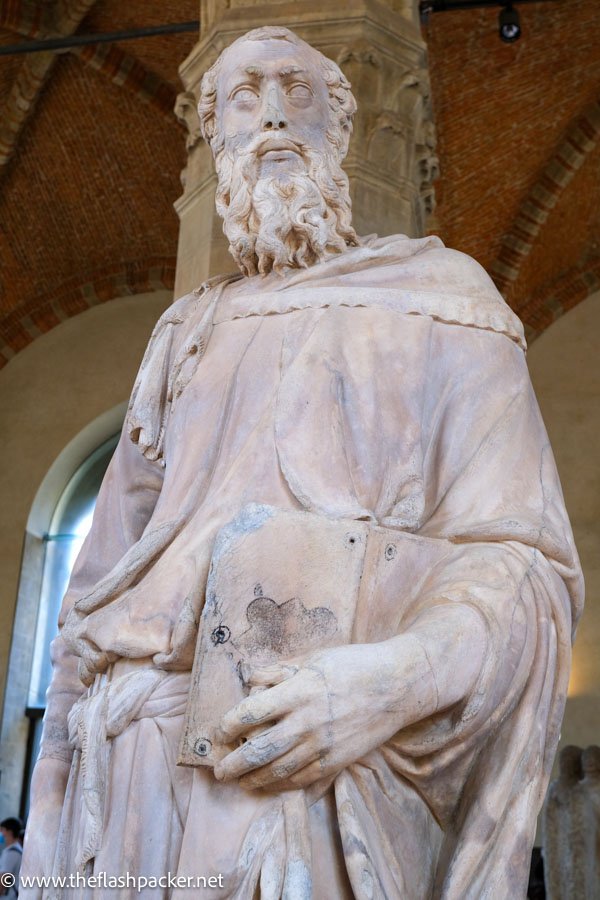 marble statue of st mark holding a gospel