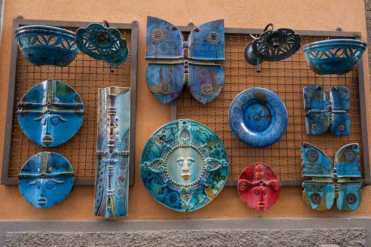 wall display of blue green and red ceramics