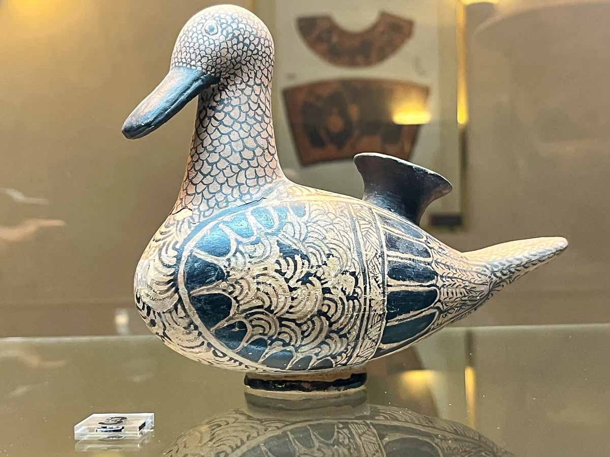 old ceramic duck painted in black and beige