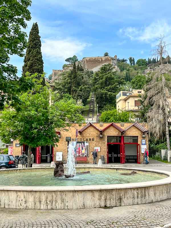 funicular station in orvieto italy behind a circular fountain