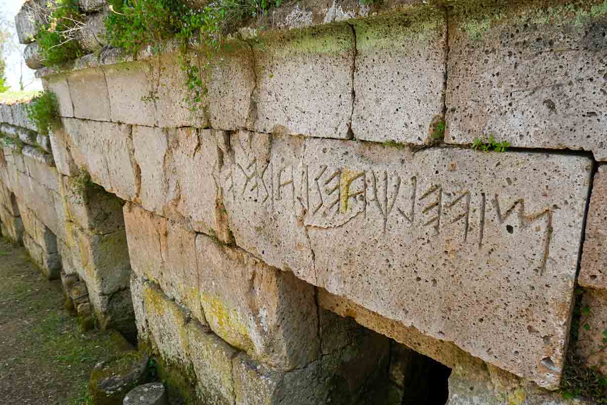 ancient etruscan writing on the stones of an ancient tomb